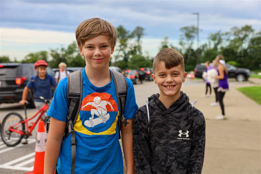Two students smile
